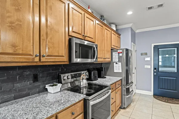 a kitchen with granite countertop a sink and a stove