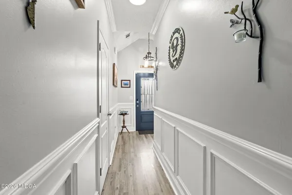 a view of hallway with wooden floor