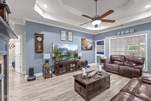 a living room with furniture a window and a flat screen tv