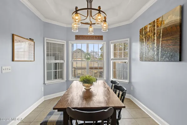 a view of a dining room with furniture window and outside view