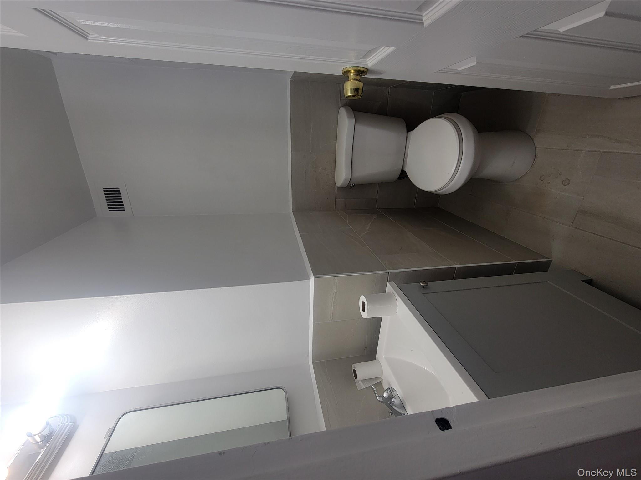 7 Fordham Hill Ovl, Unit 16C Bronx, NY 10468 - Photo 13 of 17 a bathroom with a toilet sink and mirror