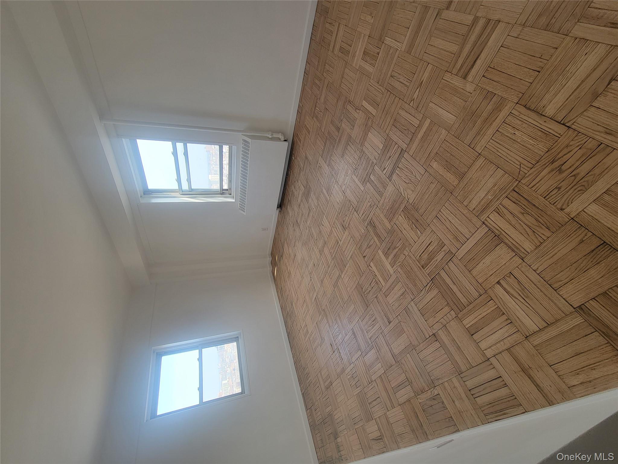 7 Fordham Hill Ovl, Unit 16C Bronx, NY 10468 - Photo 15 of 17 an empty room with windows