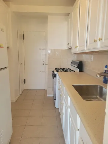 a kitchen with a sink and cabinets