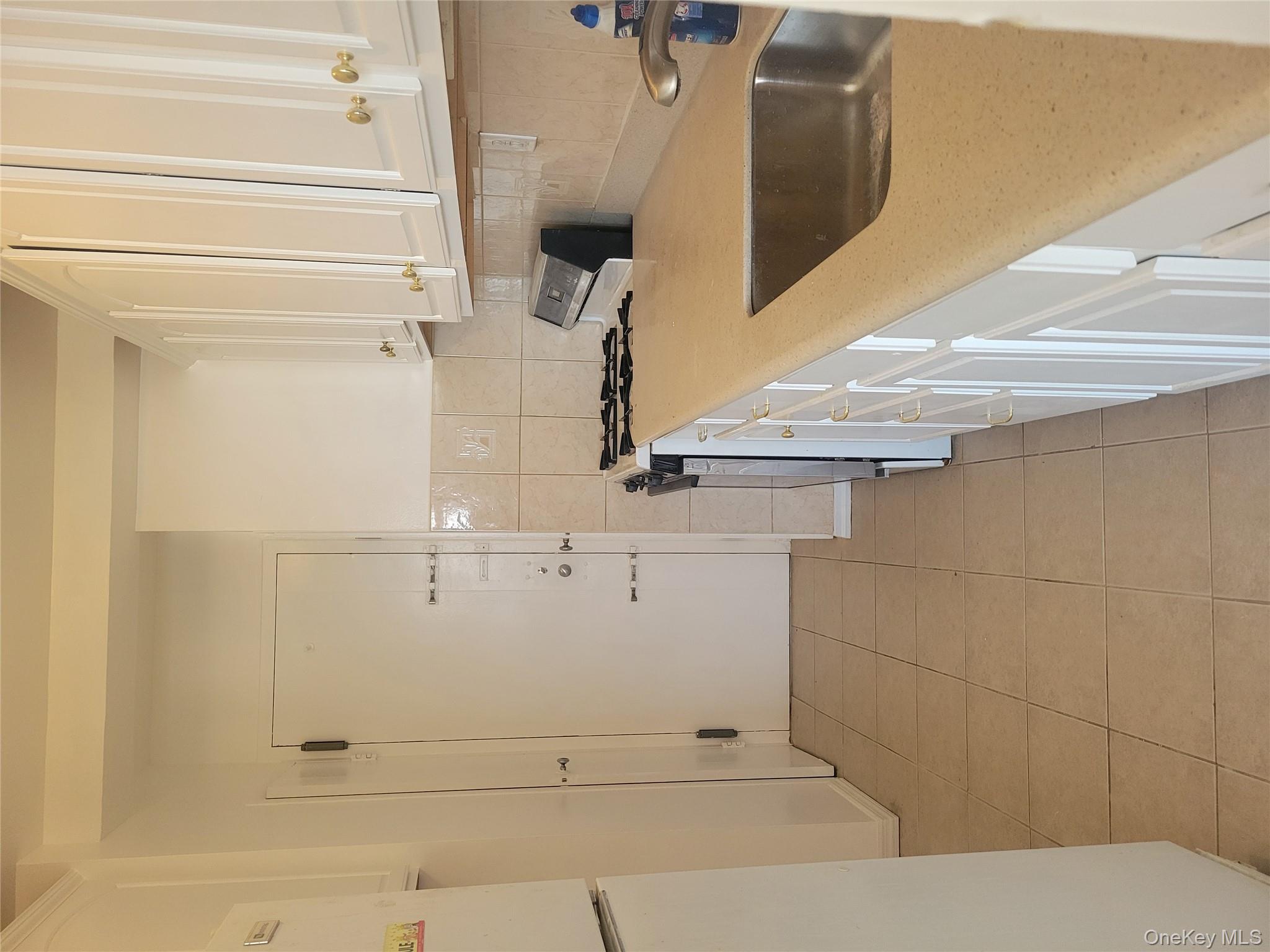 7 Fordham Hill Ovl, Unit 16C Bronx, NY 10468 - Photo 5 of 17 a kitchen with a sink and cabinets