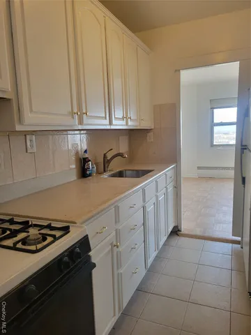 a kitchen with cabinets and appliances