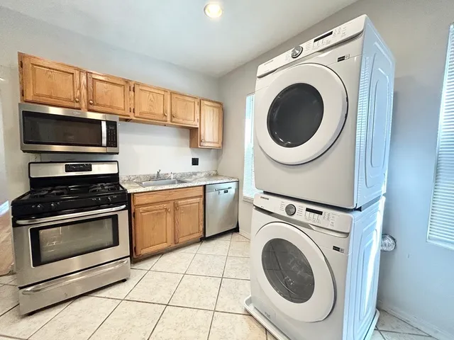 a kitchen with a stove top oven and a sink