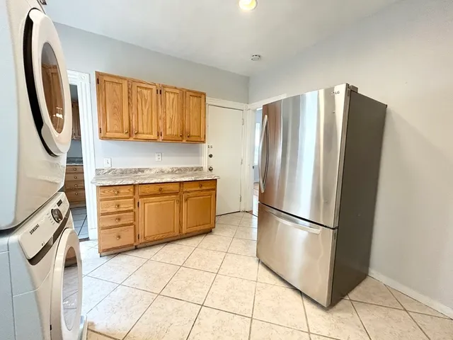 a kitchen with stainless steel appliances granite countertop a refrigerator and a stove