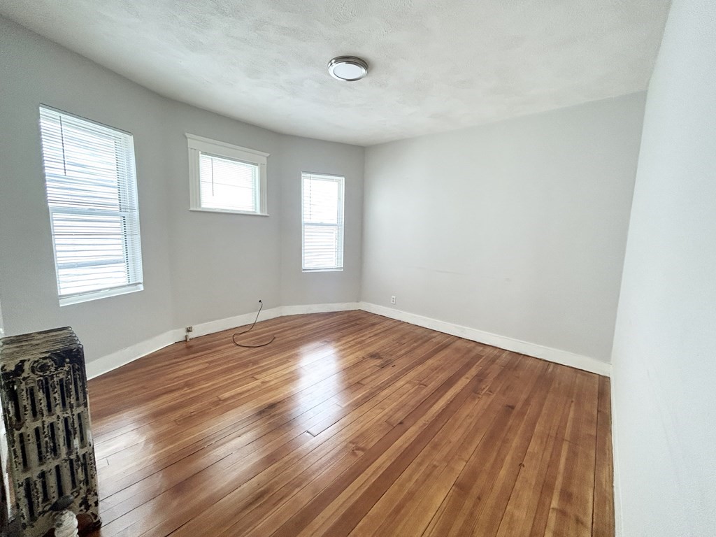 18 Eastman Street, Unit 2 Boston, MA 02125 - Photo 5 of 9 a view of empty room with wooden floor and fan