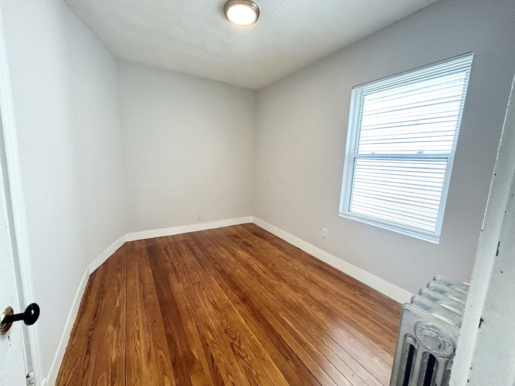 18 Eastman Street, Unit 2 Boston, MA 02125 - Photo 6 of 9 a view of a room with wooden floor and window