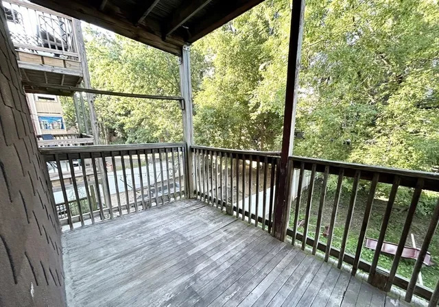 a view of a wooden balcony with outdoor space