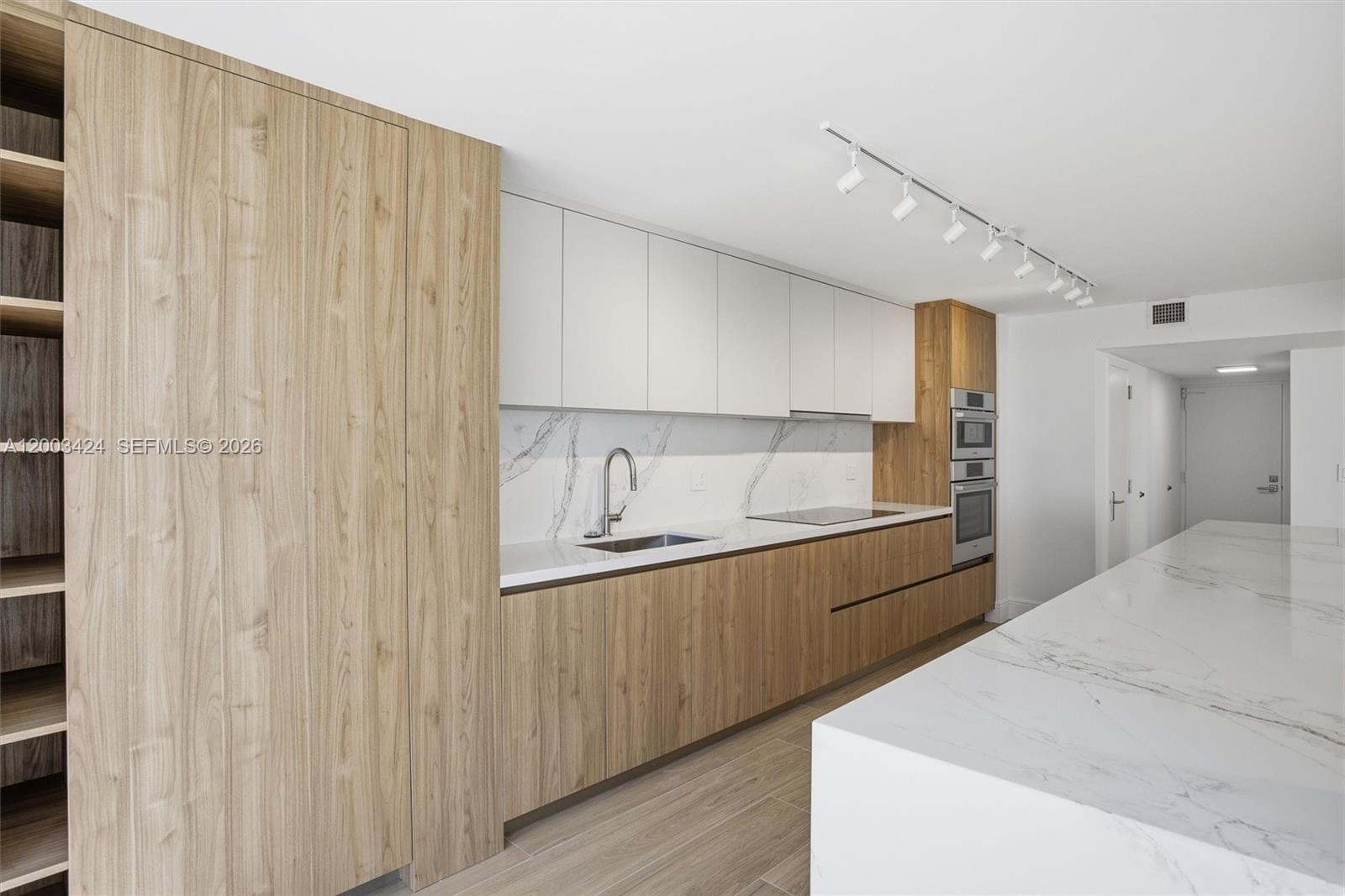 600 Grapetree Drive, Unit 4BS Key Biscayne, FL 33149 - Photo 12 of 75 a large white kitchen with a sink and dishwasher