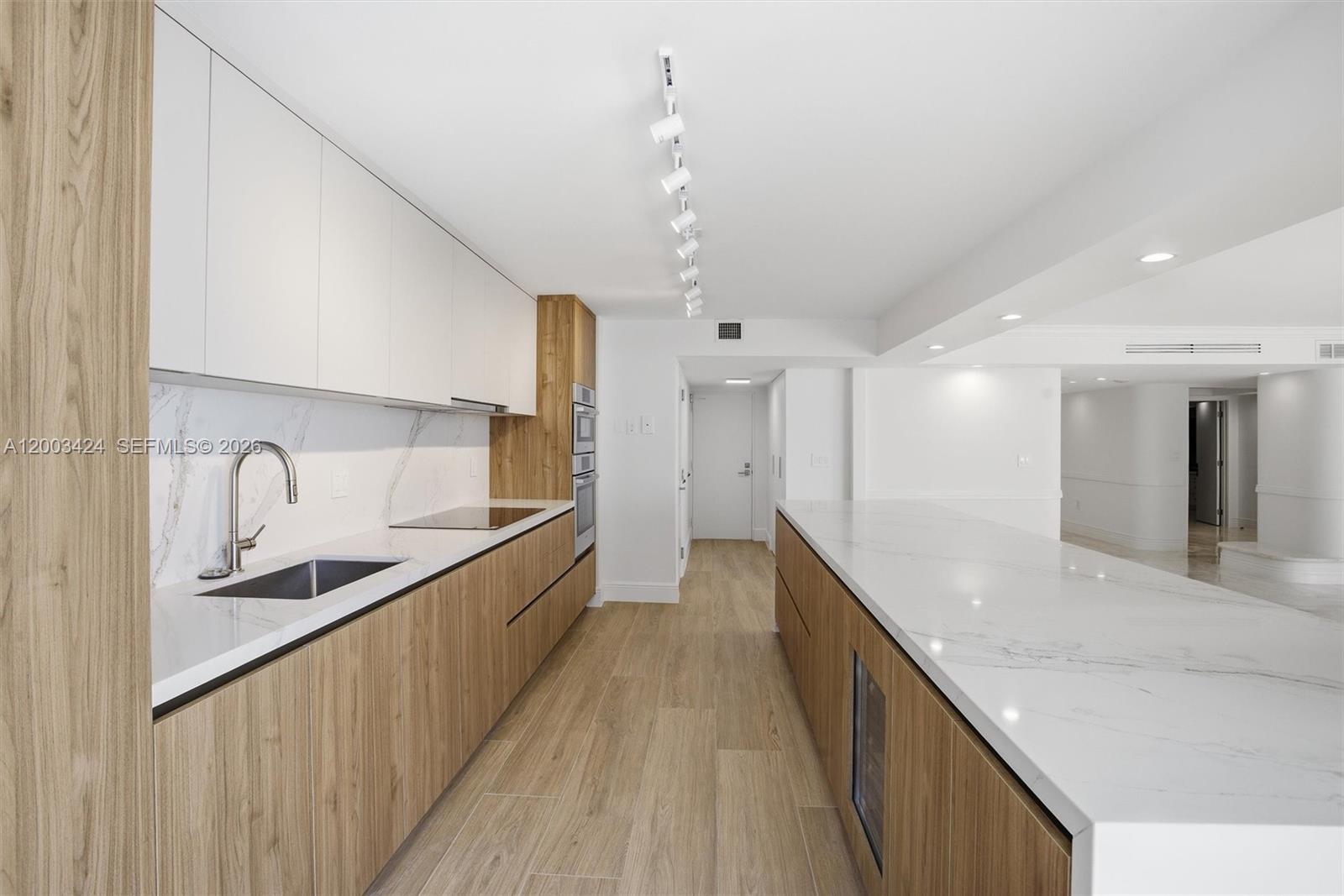 600 Grapetree Drive, Unit 4BS Key Biscayne, FL 33149 - Photo 13 of 75 a large kitchen with stainless steel appliances kitchen island granite countertop a sink and cabinets