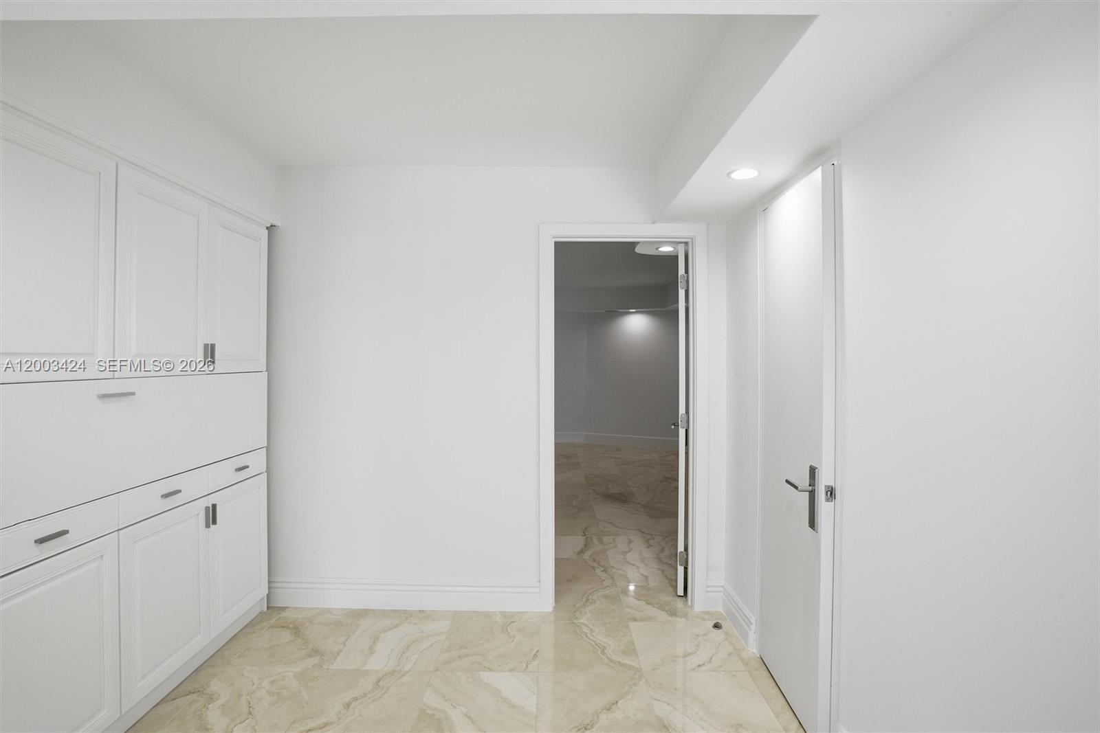 600 Grapetree Drive, Unit 4BS Key Biscayne, FL 33149 - Photo 22 of 75 an empty room with white cabinet and mirror