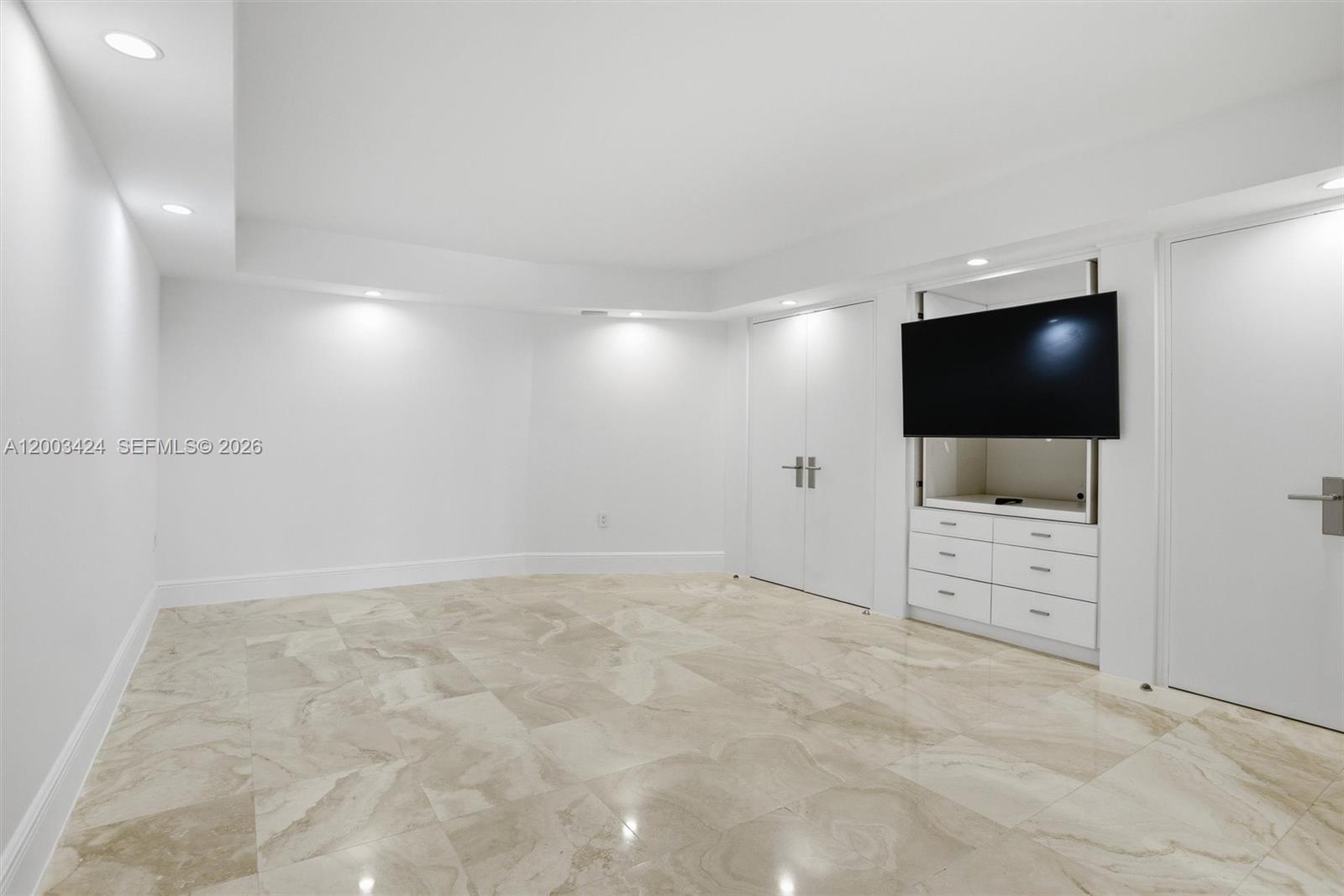 600 Grapetree Drive, Unit 4BS Key Biscayne, FL 33149 - Photo 23 of 75 an empty room with furniture and flat screen tv
