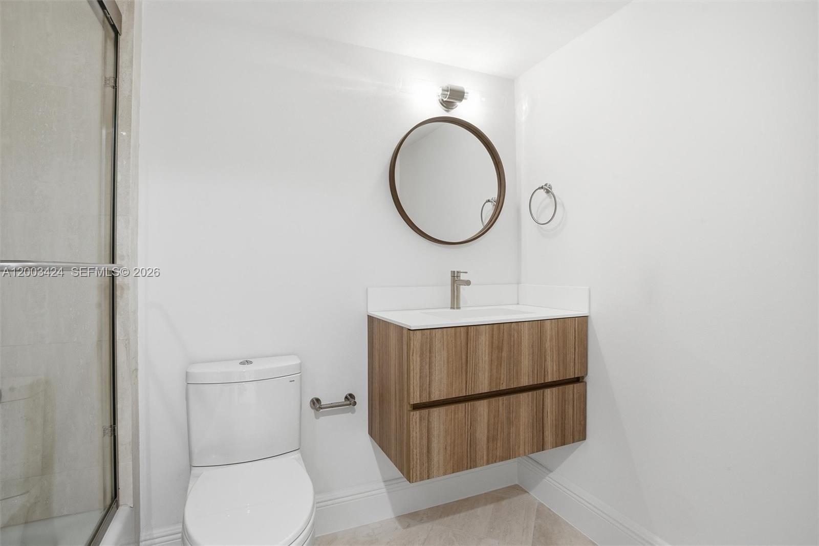 600 Grapetree Drive, Unit 4BS Key Biscayne, FL 33149 - Photo 27 of 75 a bathroom with a toilet a sink and a mirror