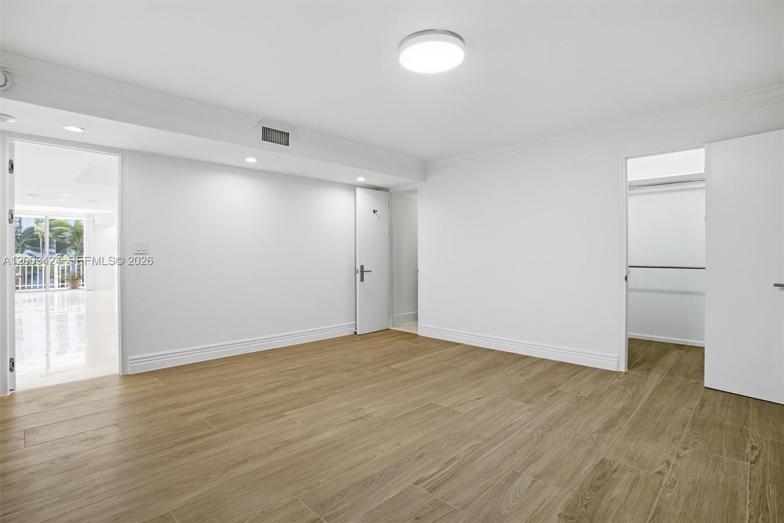 600 Grapetree Drive, Unit 4BS Key Biscayne, FL 33149 - Photo 30 of 75 an empty room with wooden floor and windows