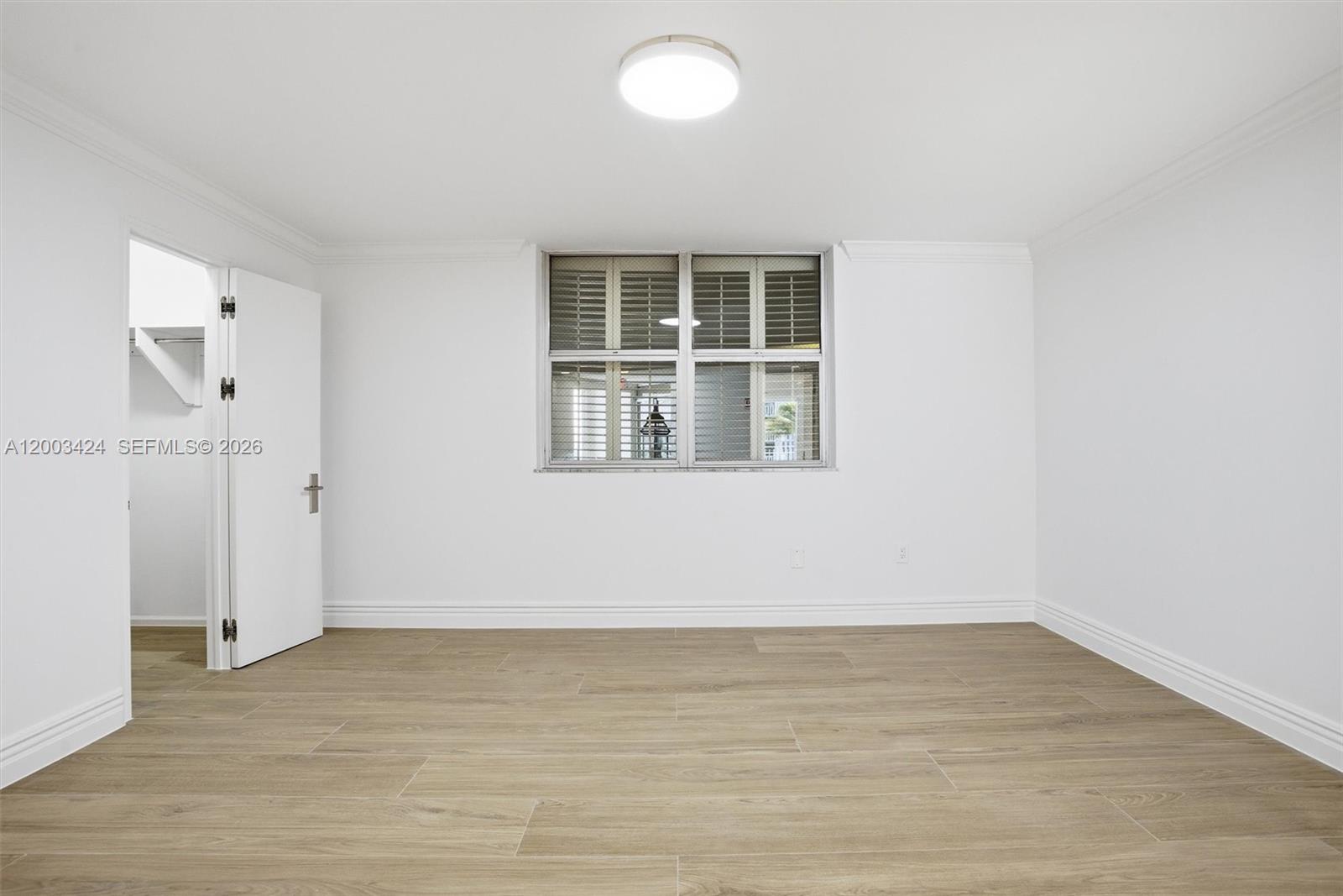 600 Grapetree Drive, Unit 4BS Key Biscayne, FL 33149 - Photo 32 of 75 a view of an empty room with wooden floor and a window