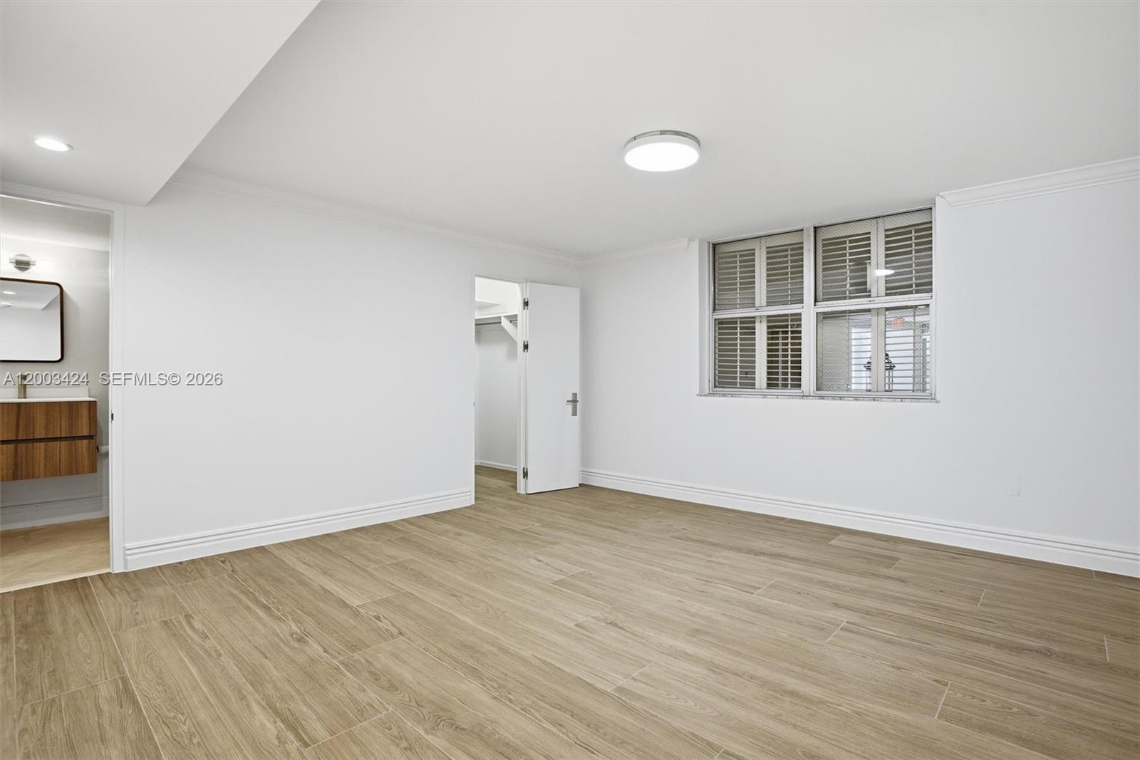 600 Grapetree Drive, Unit 4BS Key Biscayne, FL 33149 - Photo 33 of 75 an empty room with wooden floor and windows