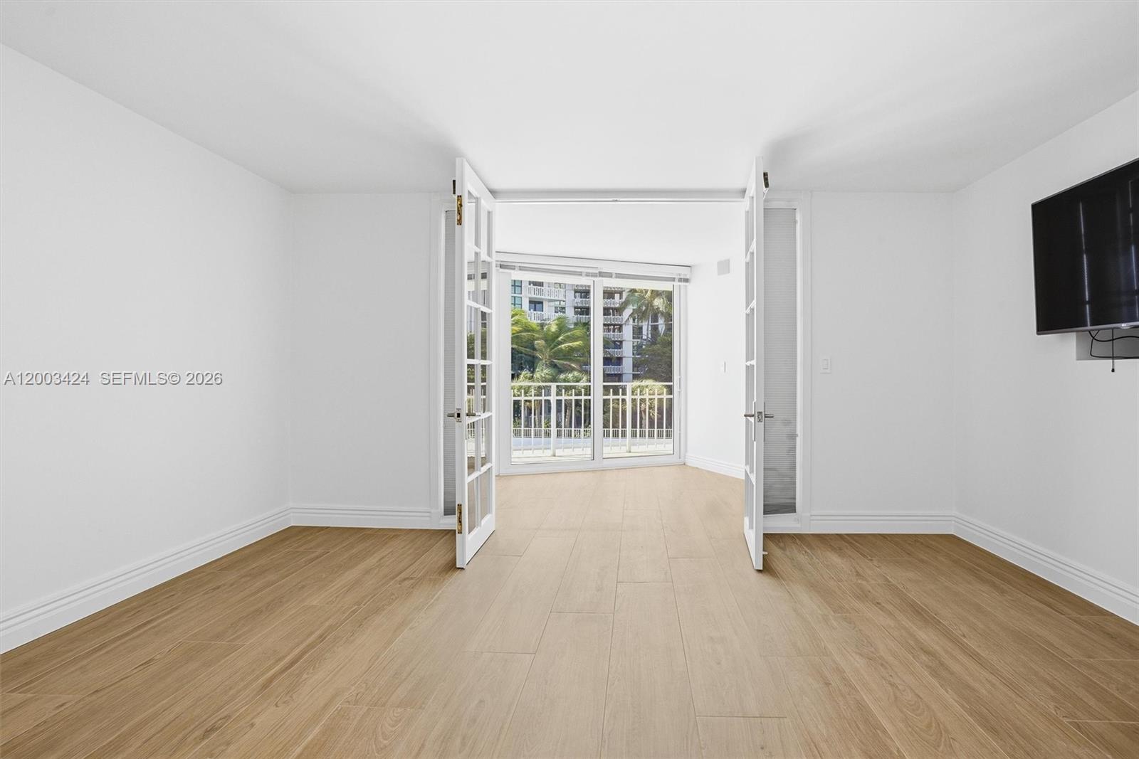 600 Grapetree Drive, Unit 4BS Key Biscayne, FL 33149 - Photo 36 of 75 a view of an empty room with wooden floor and a window