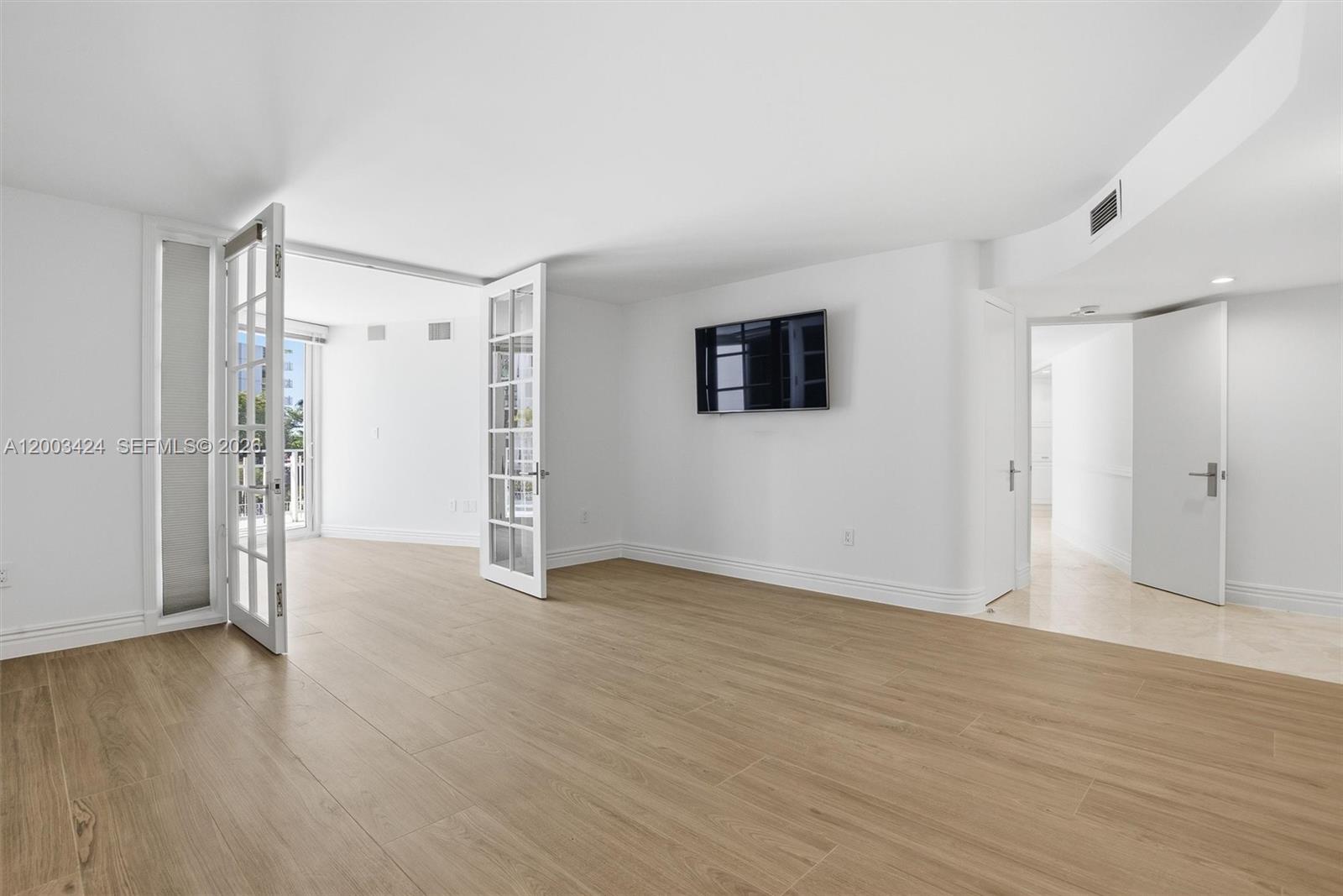 600 Grapetree Drive, Unit 4BS Key Biscayne, FL 33149 - Photo 38 of 75 a view of an empty room with wooden floor and a window