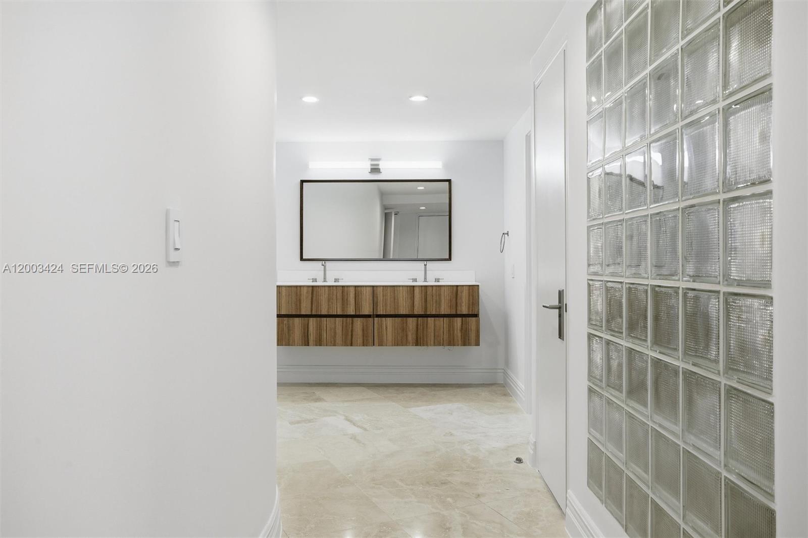 600 Grapetree Drive, Unit 4BS Key Biscayne, FL 33149 - Photo 43 of 75 a bathroom with a double vanity sink and mirror