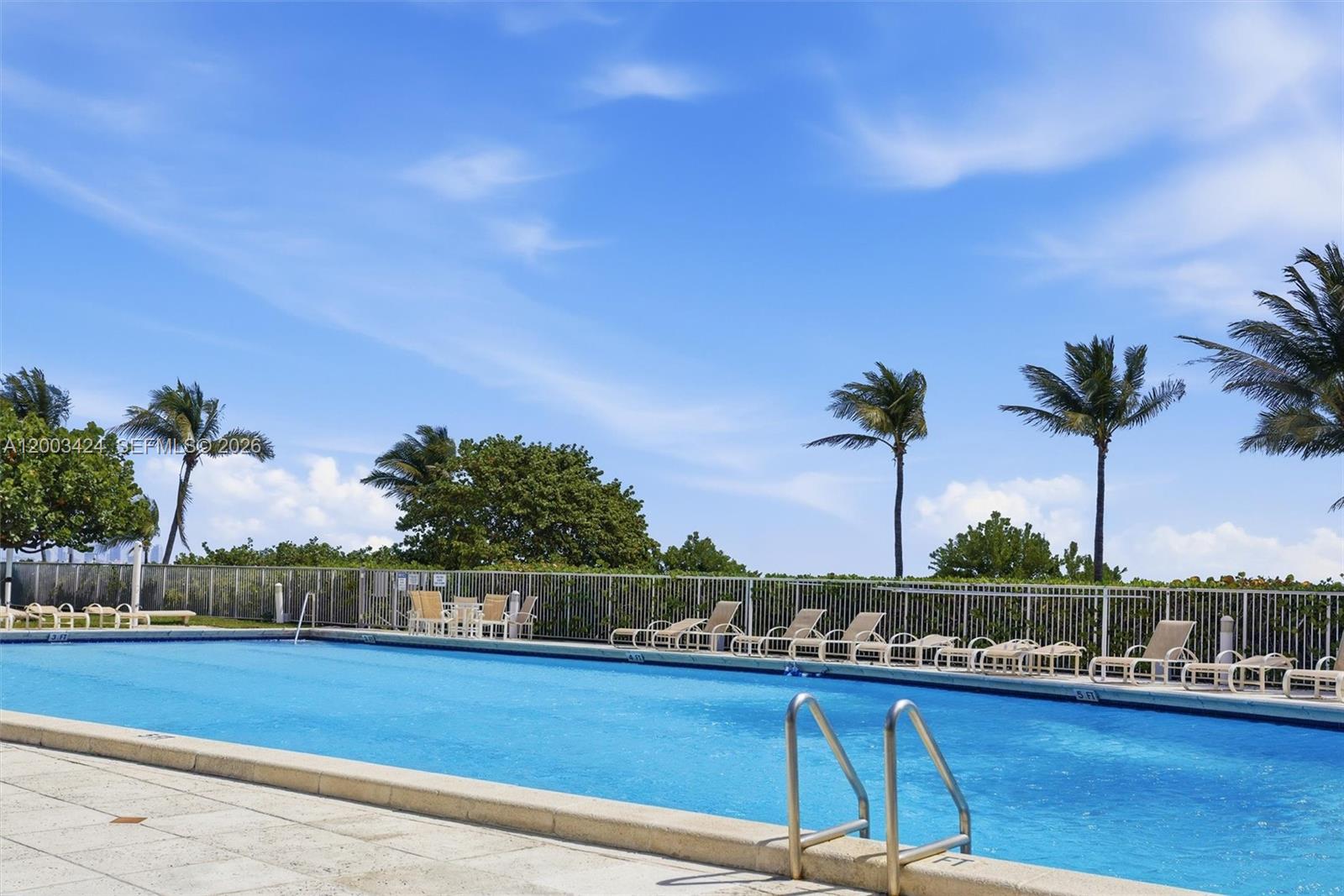 600 Grapetree Drive, Unit 4BS Key Biscayne, FL 33149 - Photo 52 of 75 a view of a swimming pool with a table and chairs