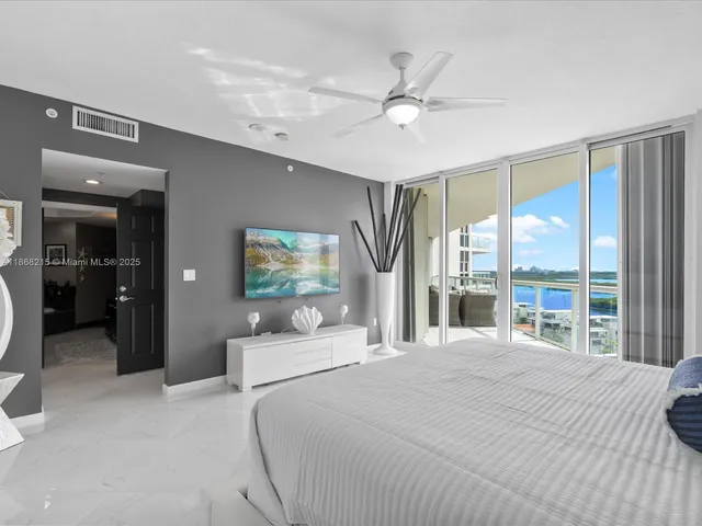 a bedroom with a large bed and a large window