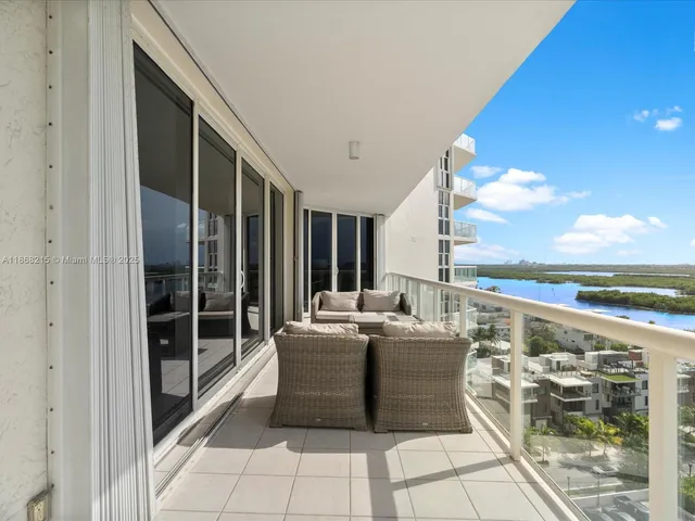 a living room with couches and balcony view