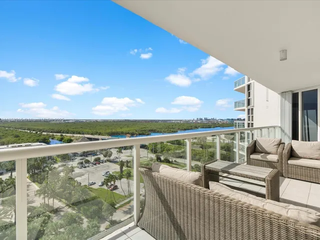 a view of roof deck with couches and city view