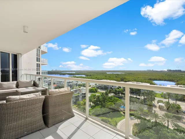 a view of a terrace with furniture and city view