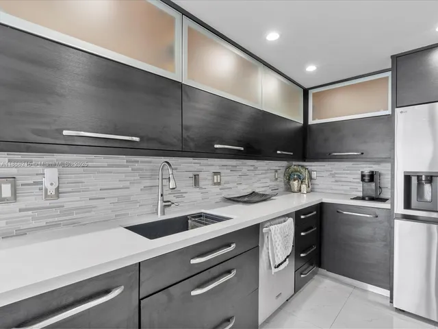 a kitchen with a sink stainless steel appliances and cabinets
