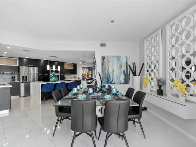 a dining room with furniture and a floor to ceiling window