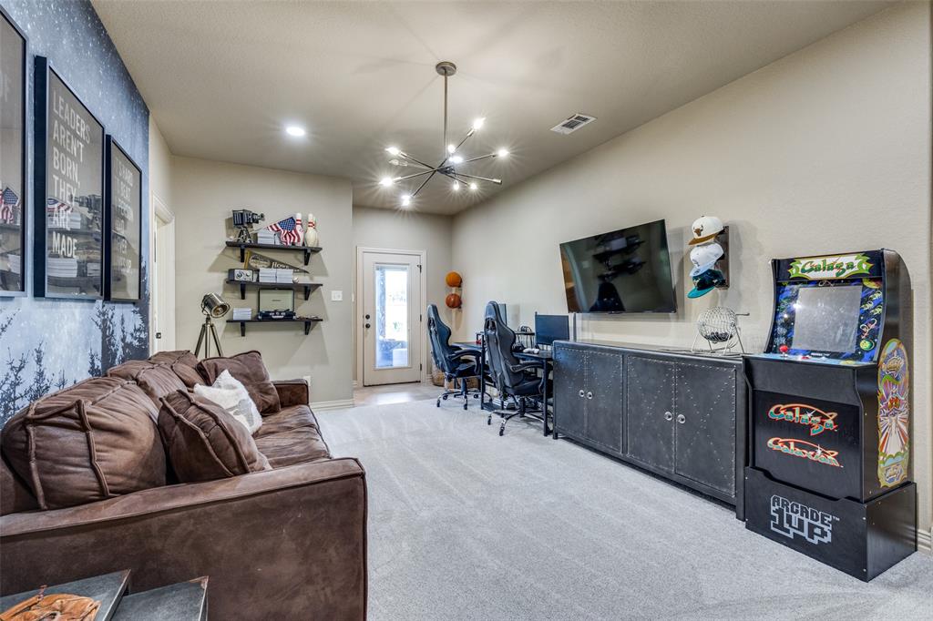 1150 Lone Star Road Bowie, TX 76230 - Photo 27 of 38 a living room with furniture and a flat screen tv