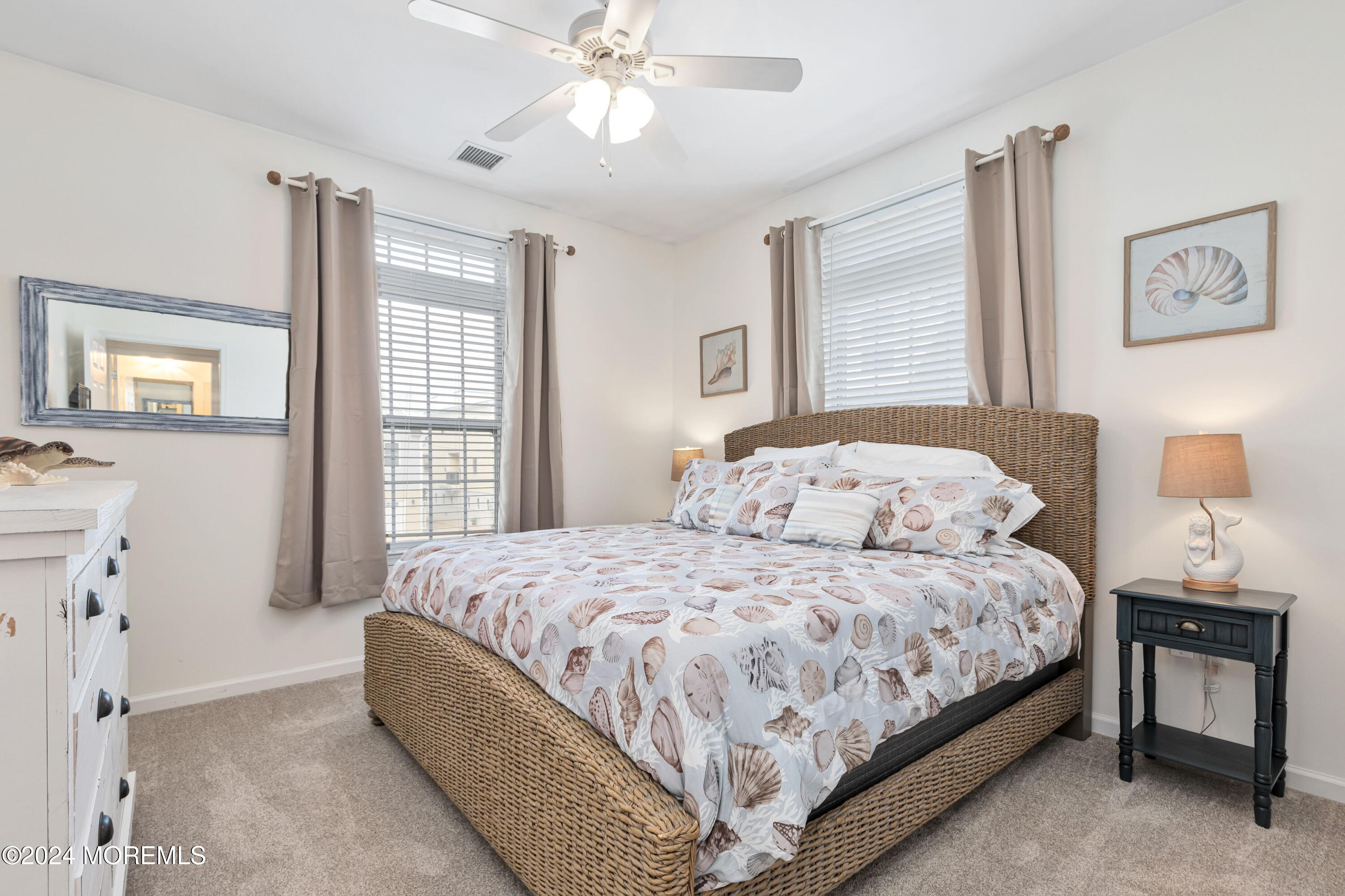 145 Flamingo Road Tuckerton, NJ 08087 - Photo 15 of 43 a bedroom with a bed and a chandelier