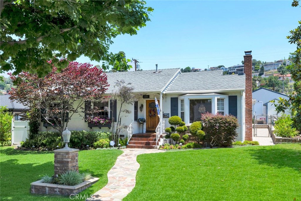 5456 Cadbury Road Whittier, CA 90601 - Photo 42 of 67 a front view of a house with garden
