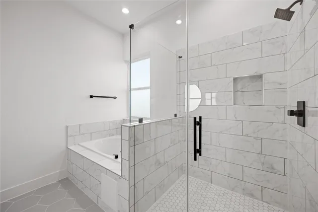a spacious bathroom with a bathtub and a shower