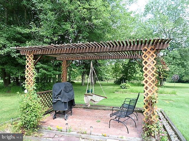 522 East Creamery Road Perkasie, PA 18944 - Photo 34 of 46 Trellis & Paver Patio with hanging swing chair