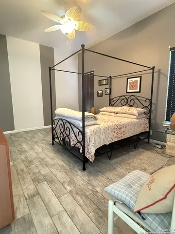 a bed sitting in a bedroom next to a window