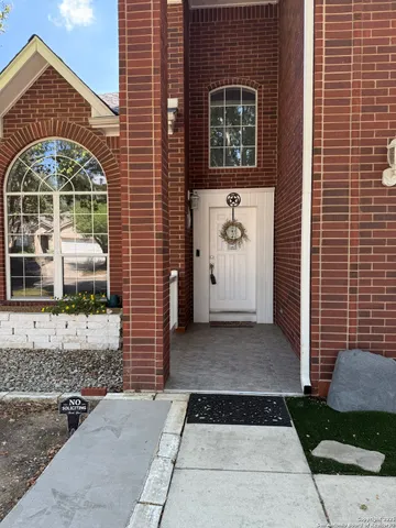 a view of a brick house with a large windows