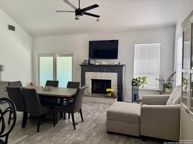a living room with furniture a flat screen tv and a fireplace