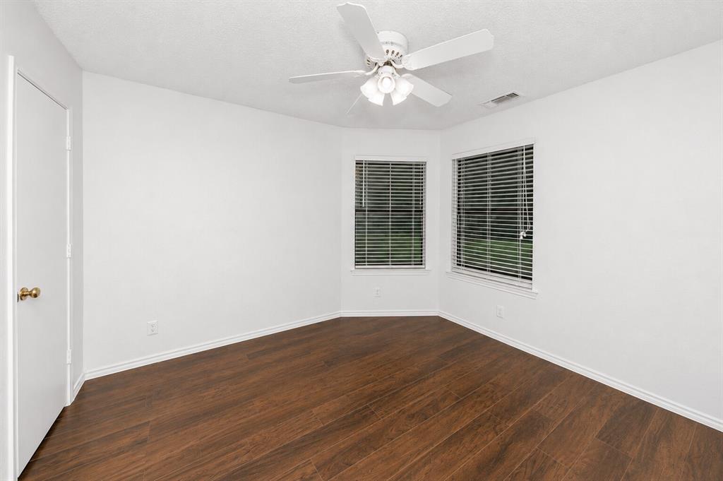 1001 Rosebud Drive Azle, TX 76020 - Photo 18 of 36 Interior room featuring white walls, dark wood-finish flooring, and white trim