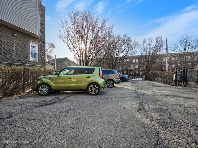 a view of a backyard with a car parked on the road