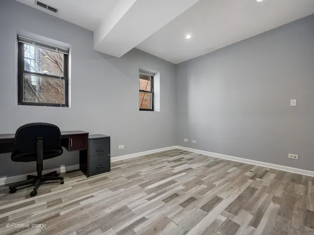 a view of workspace with wooden floor and furniture