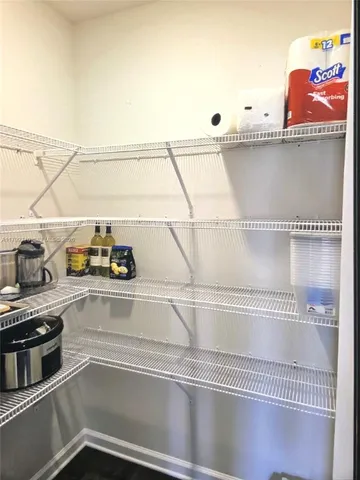 a view of a livingroom with an empty space and a window