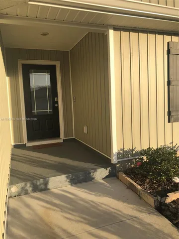 a view of a door of a house and car parked front of a house
