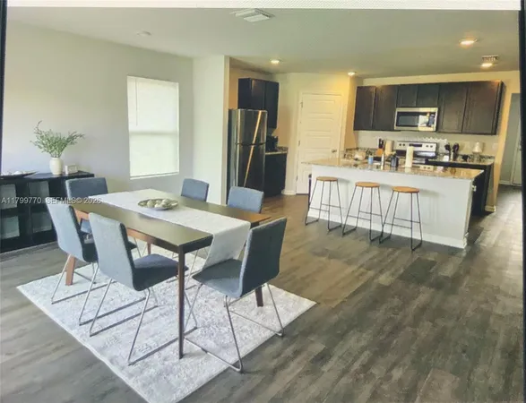 a living room with kitchen island furniture and a kitchen view
