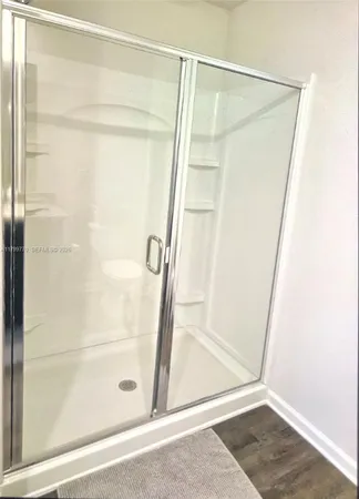 a bathroom with a granite countertop sink a toilet and a mirror