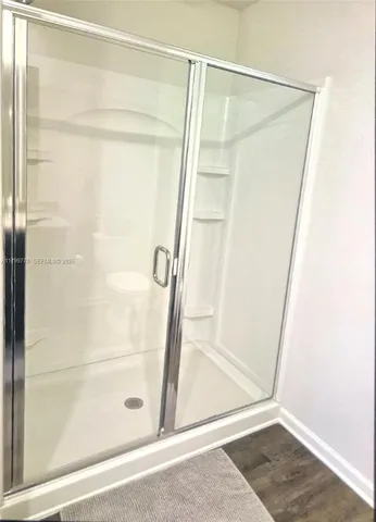 a bathroom with a granite countertop sink a toilet and a mirror