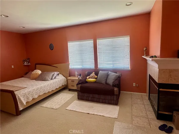 a bedroom with a bed and a fireplace
