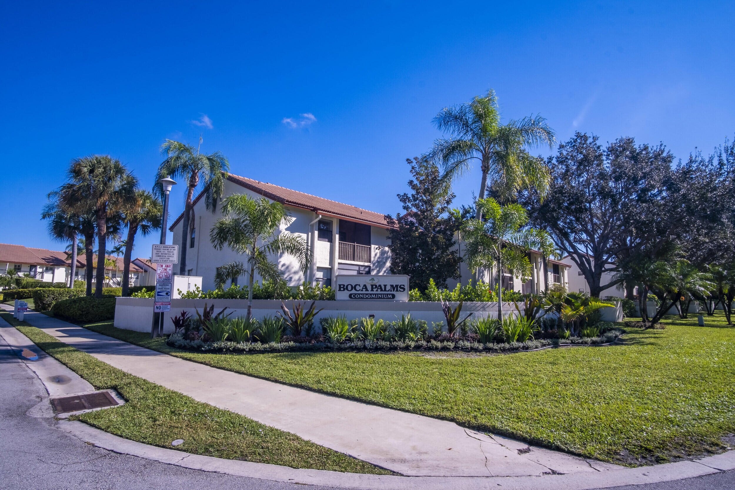 22076 Palms Way, Unit 203 Boca Raton, FL 33433 - Photo 23 of 25 a front view of a house with garden